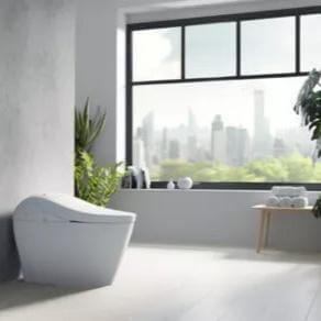 Modern bathroom featuring TOTO G5A smart toilet with integrated bidet seat and city view through large windows