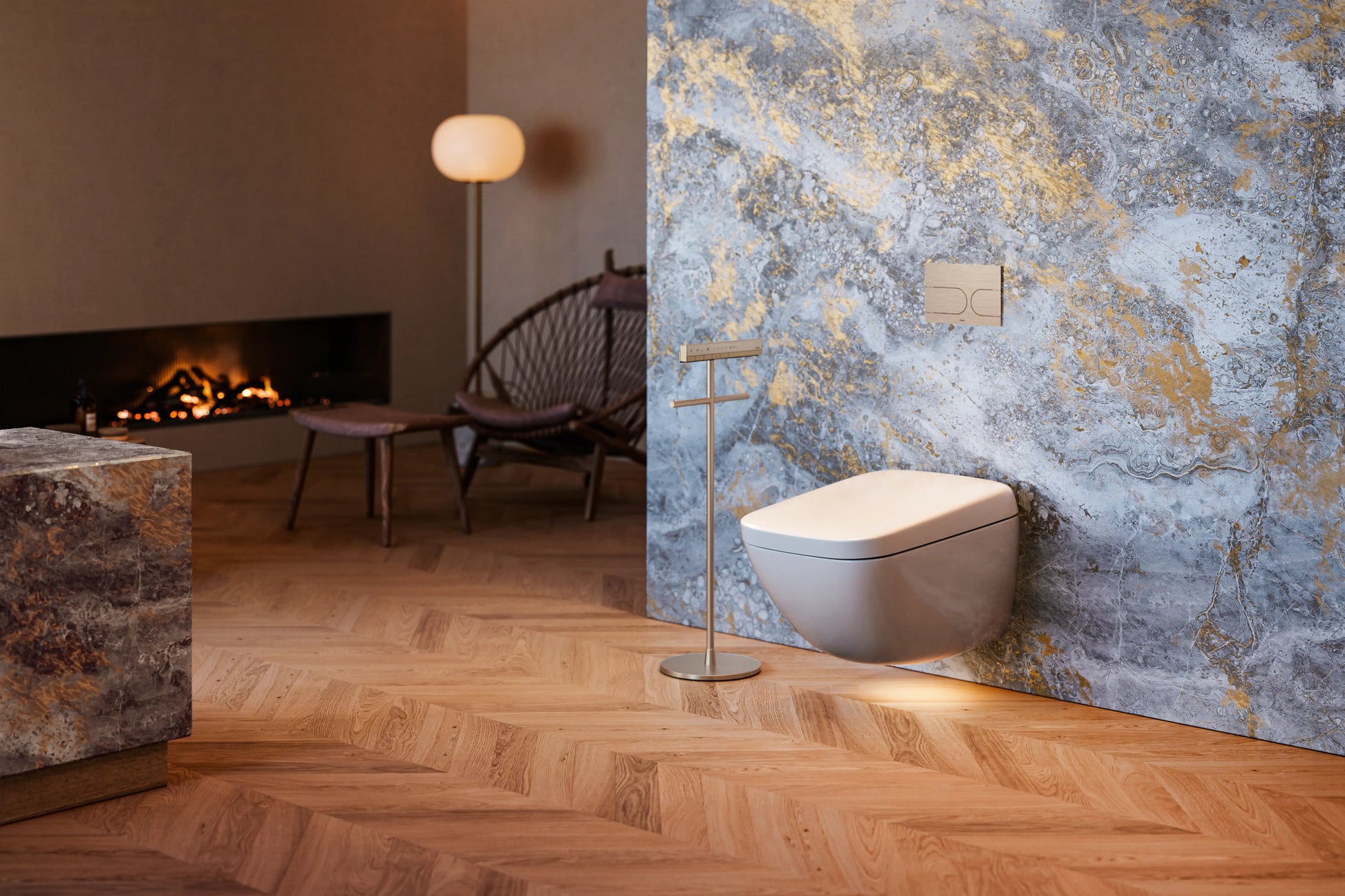 TOTO NEOREST WX2 wall-hung toilet installed in a luxury bathroom with a fireplace, stone wall and herringbone wood floor